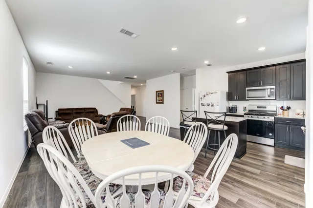 a kitchen with granite countertop cabinets stainless steel appliances and wooden floor