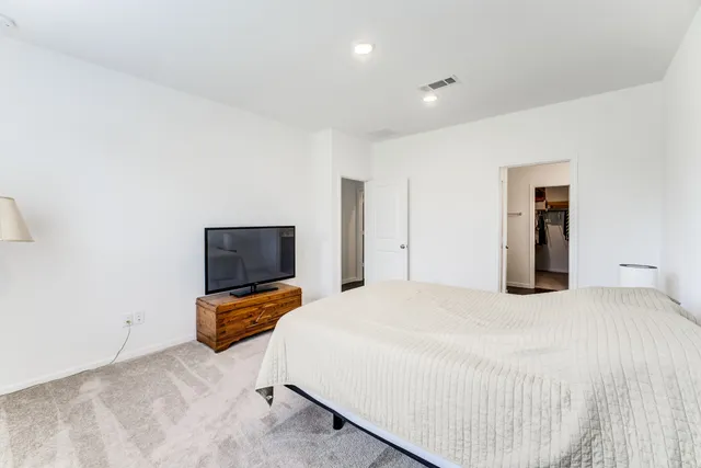 a bed room with a bed and a chair