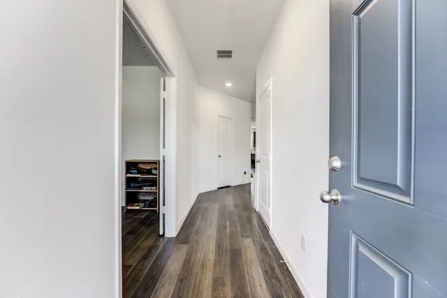 a view of room with wooden floor and closet