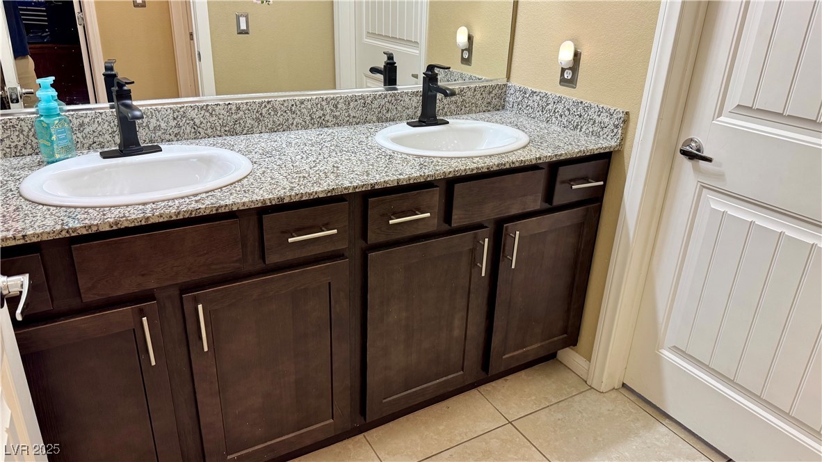 2293 Chandler Ranch Place Laughlin, NV 89029 - Photo 12 of 23 Bathroom with double vanity, light tile patterned flooring, and a textured wall