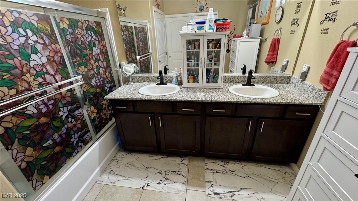 2293 Chandler Ranch Place Laughlin, NV 89029 - Photo 20 of 23 Full bathroom featuring double vanity and bath / shower combo with glass door