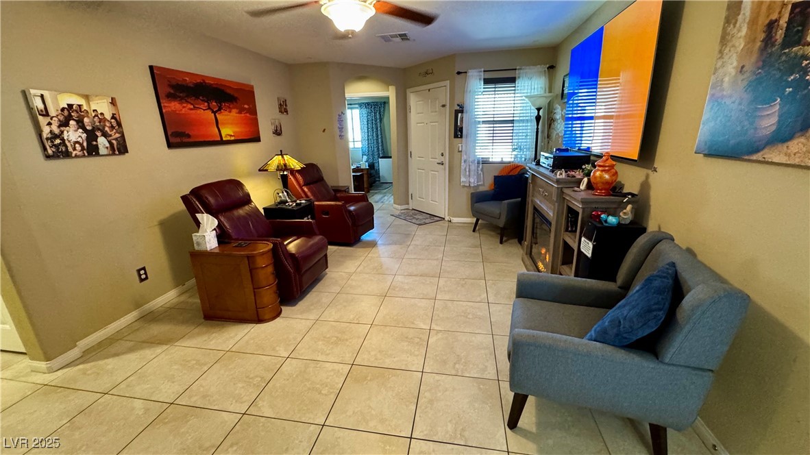 2293 Chandler Ranch Place Laughlin, NV 89029 - Photo 8 of 23 Sitting room featuring light tile patterned floors and a ceiling fan