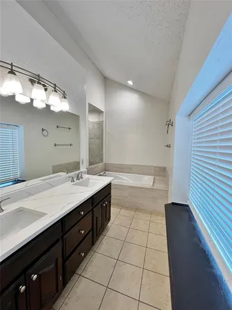 a bathroom with a sink a large mirror and a shower