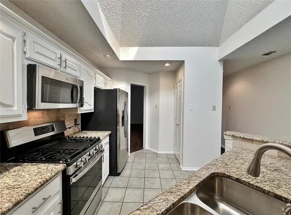 a kitchen with a sink and a stove top oven