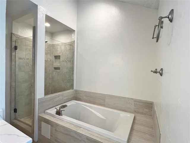 a bathroom with a tub and shower