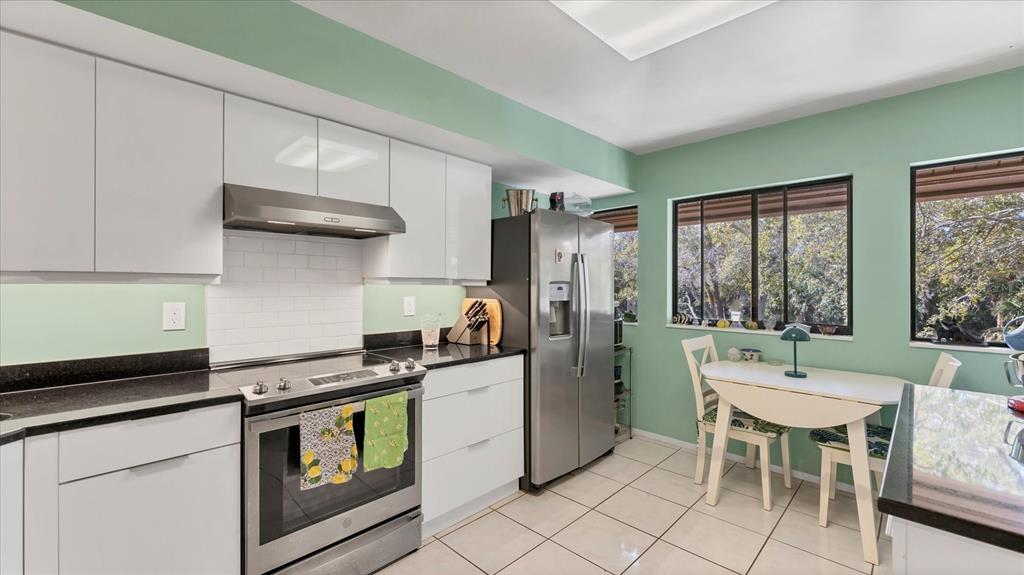 4957 Cross Creek Road, Unit 4957 Sarasota, FL 34231 - Photo 11 of 32 a kitchen with stainless steel appliances a stove a sink and a refrigerator