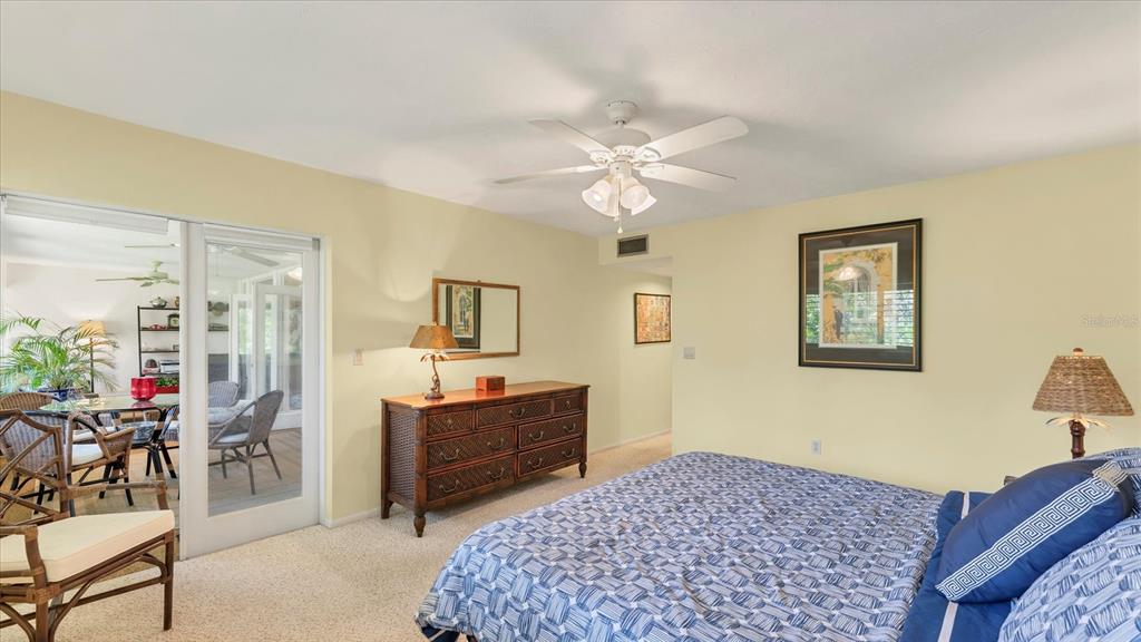4957 Cross Creek Road, Unit 4957 Sarasota, FL 34231 - Photo 16 of 32 a bedroom with a bed and wooden floor