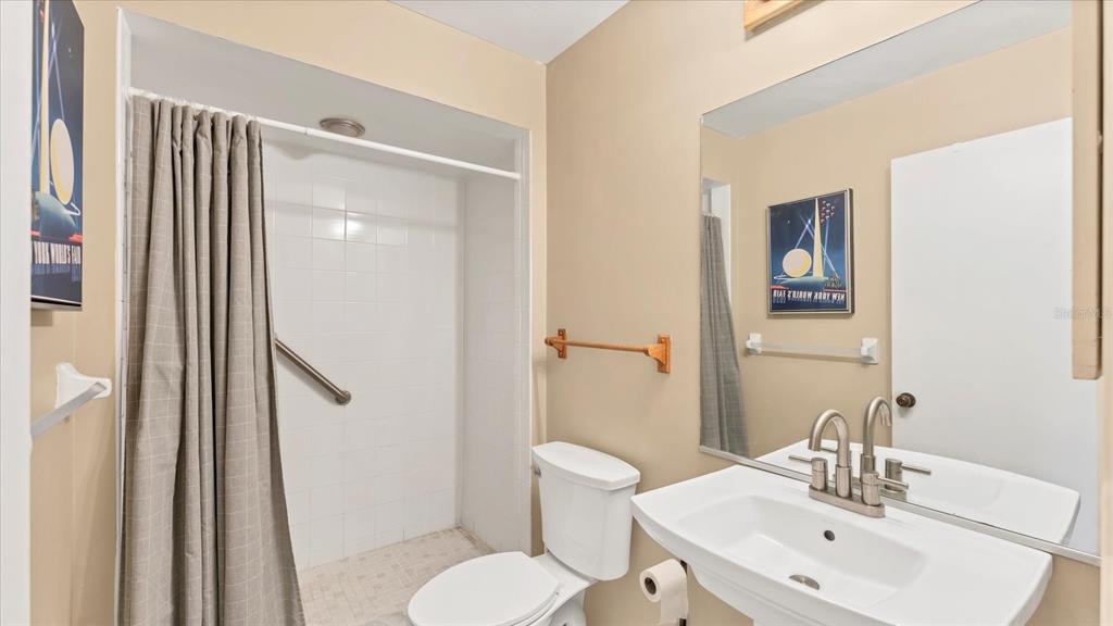 4957 Cross Creek Road, Unit 4957 Sarasota, FL 34231 - Photo 19 of 32 a bathroom with a sink toilet and shower
