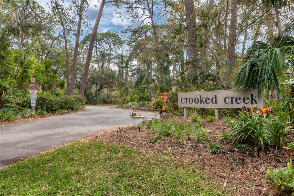 4957 Cross Creek Road, Unit 4957 Sarasota, FL 34231 - Photo 24 of 32 a sign on the side of a road