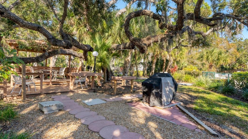 4957 Cross Creek Road, Unit 4957 Sarasota, FL 34231 - Photo 25 of 32 a view of a yard with plants