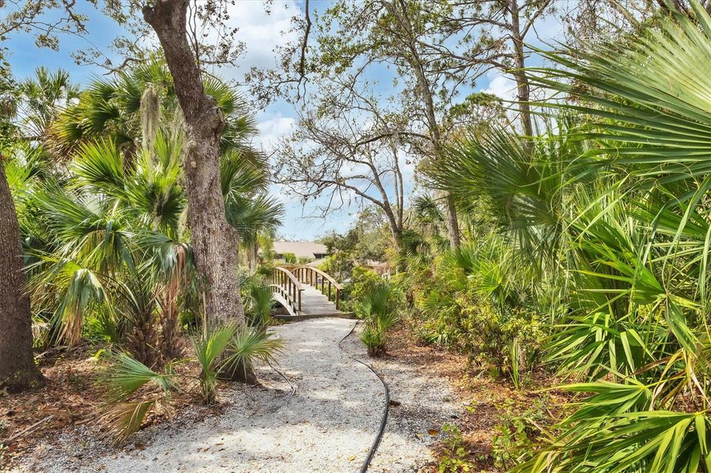 4957 Cross Creek Road, Unit 4957 Sarasota, FL 34231 - Photo 28 of 32 a view of a yard with plants and trees