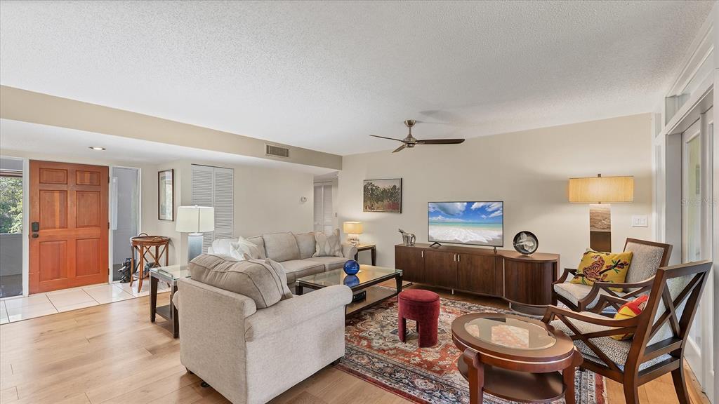 4957 Cross Creek Road, Unit 4957 Sarasota, FL 34231 - Photo 3 of 32 a living room with furniture and a wooden floor