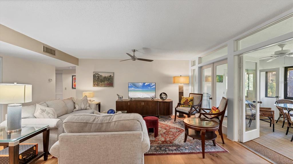 4957 Cross Creek Road, Unit 4957 Sarasota, FL 34231 - Photo 6 of 32 a living room with furniture and a wooden floor