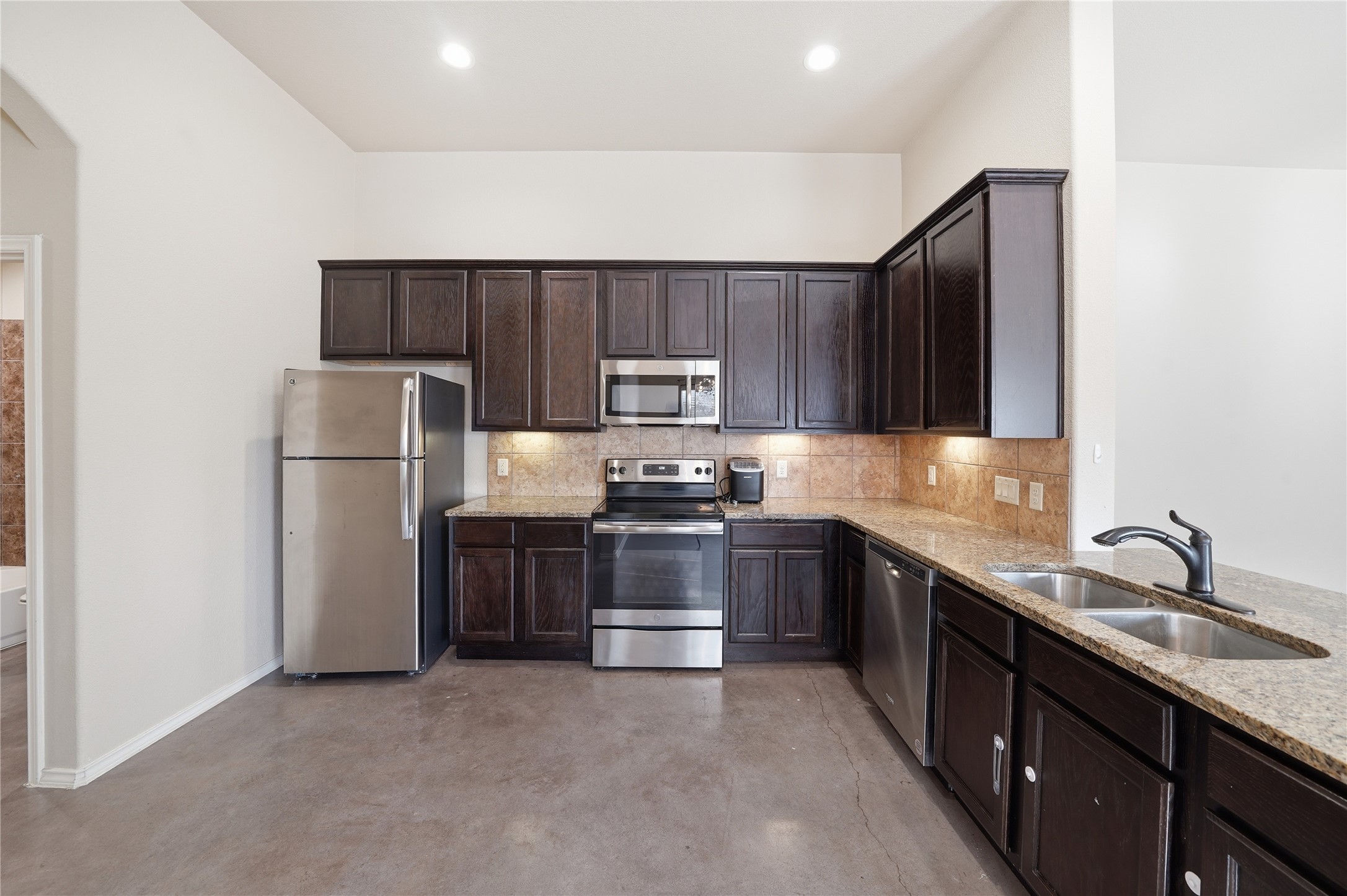 533 Jack Rabbit Lane, Unit A Buda, TX 78610 - Photo 14 of 34 Ample counter space and dark cabinetry define this functional, well-lit kitchen.
