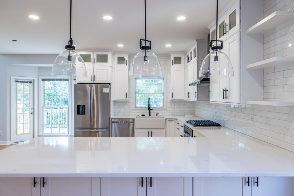 1759 Regency Park Walk Atlanta, GA 30341 - Photo 14 of 61 a large kitchen with stainless steel appliances a large counter top a stove a refrigerator a sink and a large window