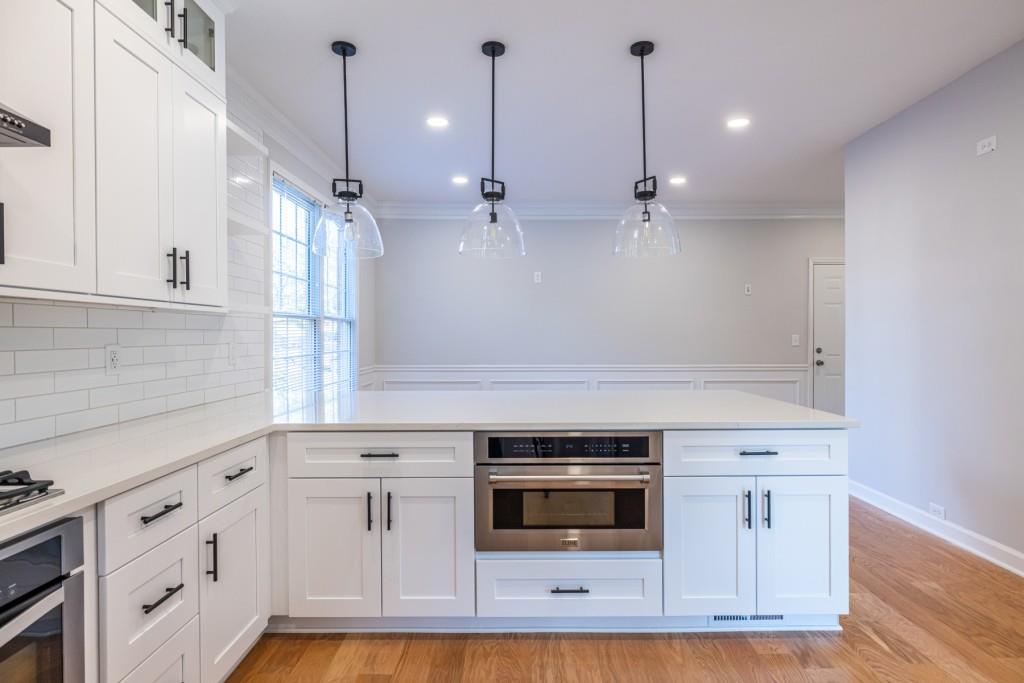 1759 Regency Park Walk Atlanta, GA 30341 - Photo 15 of 61 a kitchen with white cabinets and appliances