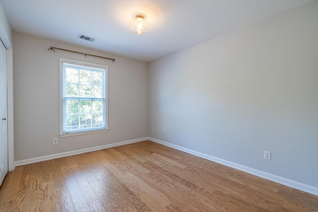 1759 Regency Park Walk Atlanta, GA 30341 - Photo 20 of 61 an empty room with wooden floor and windows