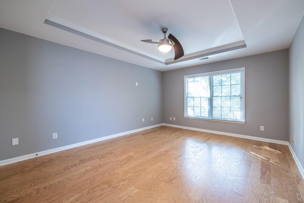 1759 Regency Park Walk Atlanta, GA 30341 - Photo 22 of 61 a view of an empty room with wooden floor and a window