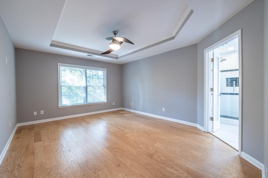 1759 Regency Park Walk Atlanta, GA 30341 - Photo 24 of 61 a view of an empty room with a window and wooden floor