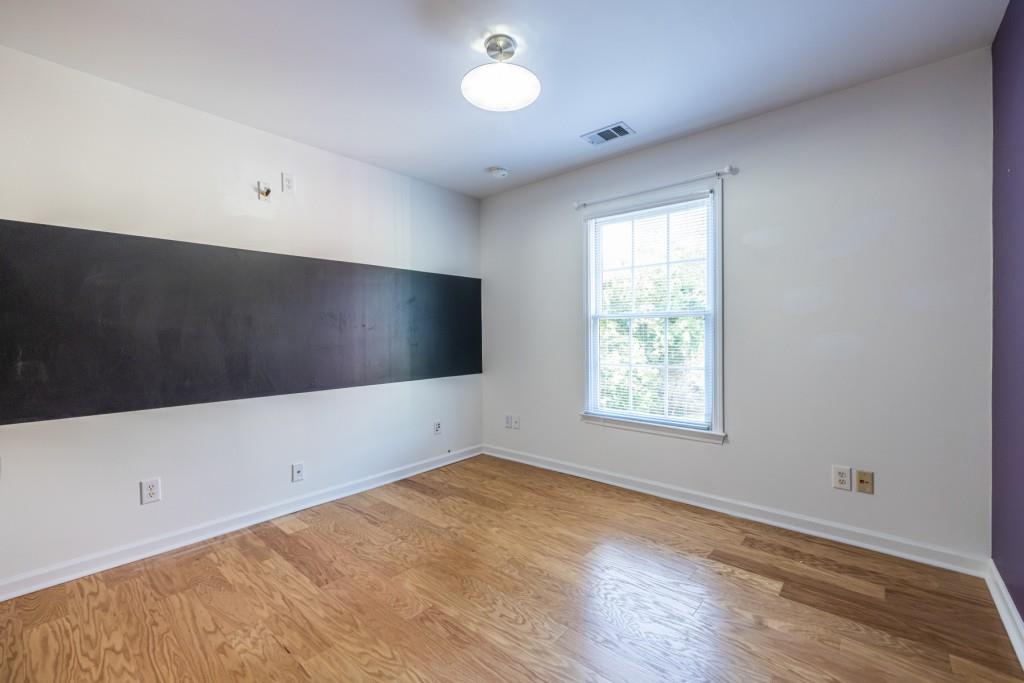1759 Regency Park Walk Atlanta, GA 30341 - Photo 32 of 61 a view of an empty room with wooden floor and a window