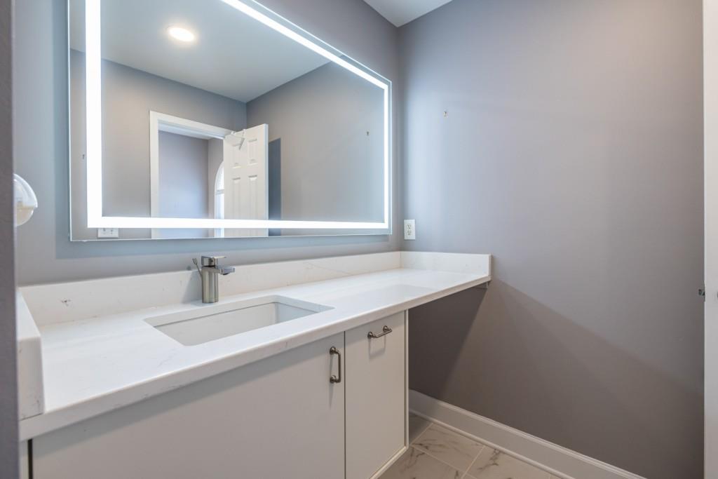 1759 Regency Park Walk Atlanta, GA 30341 - Photo 34 of 61 a bathroom with a sink and a mirror