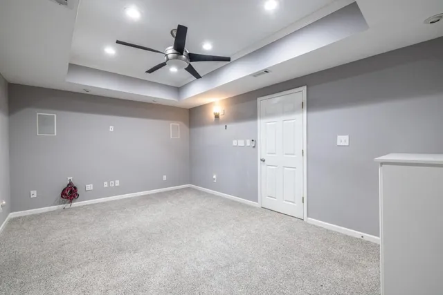 a view of a yard with plants and wooden fence