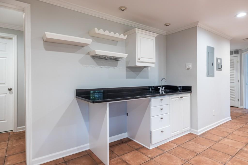 1759 Regency Park Walk Atlanta, GA 30341 - Photo 45 of 61 a kitchen with white cabinets and white appliances