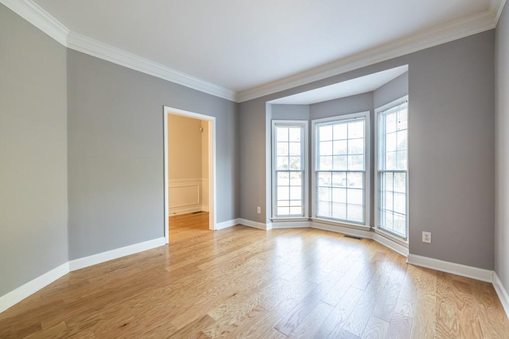 1759 Regency Park Walk Atlanta, GA 30341 - Photo 5 of 61 a view of an empty room with wooden floor and a window