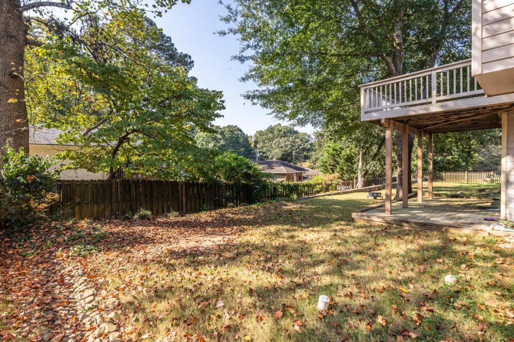 1759 Regency Park Walk Atlanta, GA 30341 - Photo 53 of 61 a view of a yard with plants and wooden fence