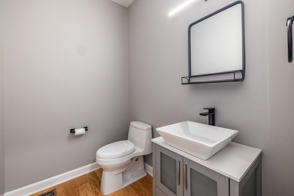 1759 Regency Park Walk Atlanta, GA 30341 - Photo 54 of 61 a bathroom with a toilet a sink and mirror