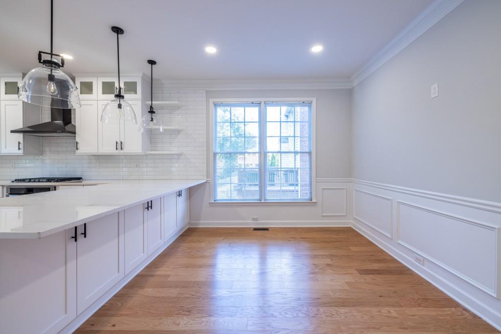 1759 Regency Park Walk Atlanta, GA 30341 - Photo 55 of 61 a large kitchen with cabinets and wooden floor