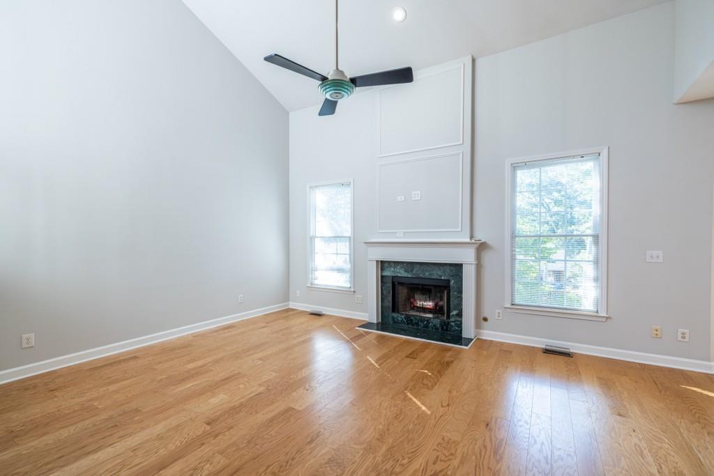 1759 Regency Park Walk Atlanta, GA 30341 - Photo 7 of 61 a view of empty room with a fireplace and wooden floor