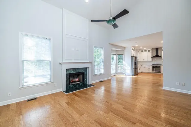 a large white kitchen with stainless steel appliances