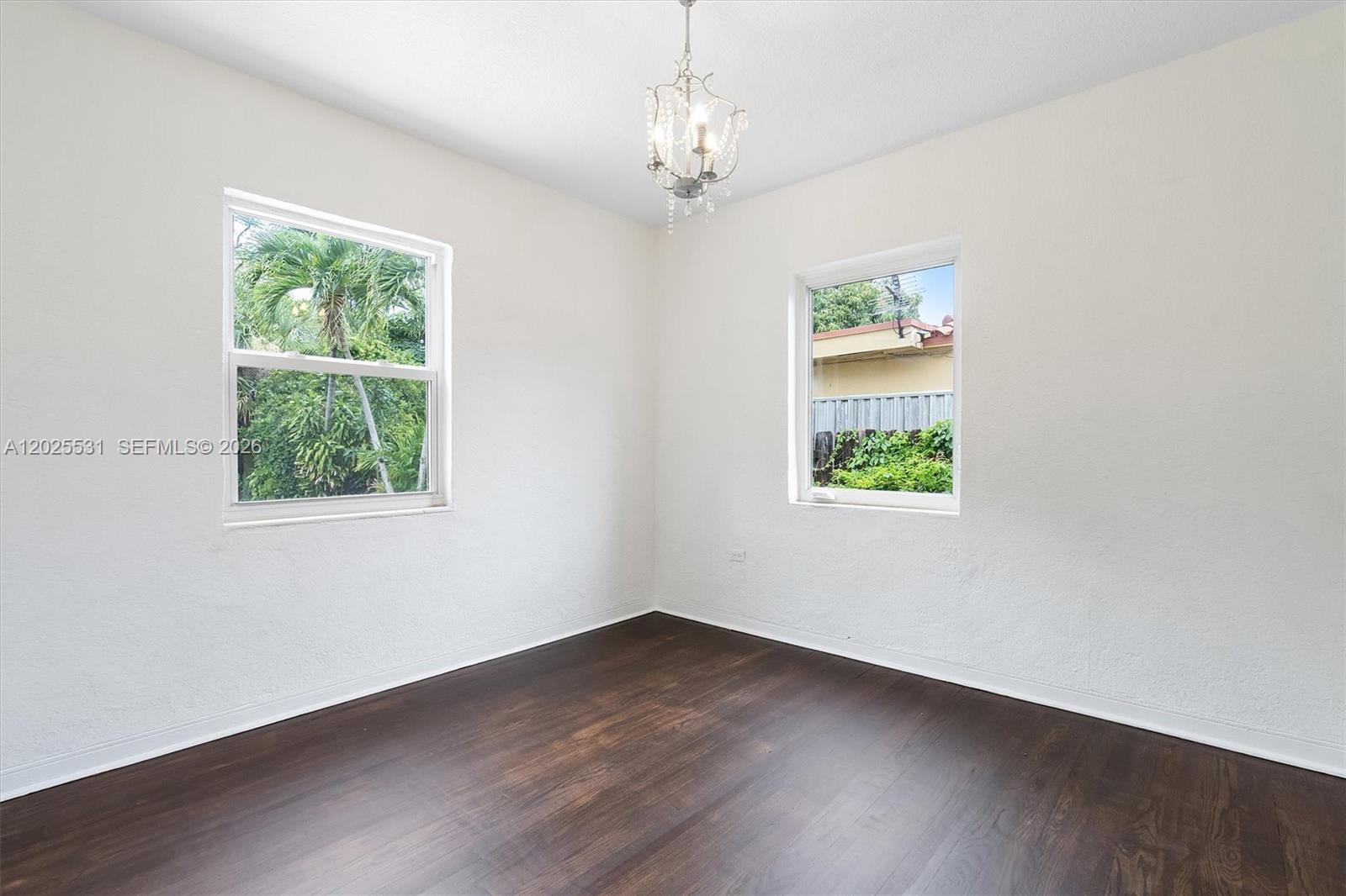 3951 Southwest 2nd Terrace, Unit 3951 Miami, FL 33134 - Photo 8 of 21 a view of an empty room with wooden floor and window