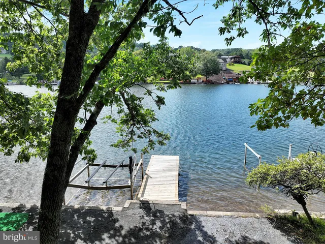 an aerial view of a house with a yard and lake view