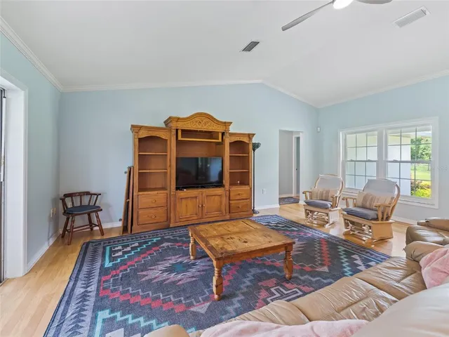 a living room with furniture a rug and a table