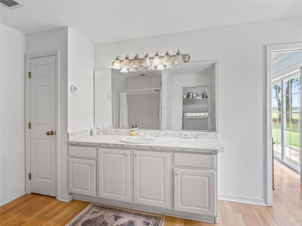 1500 Northwest 155th Street Citra, FL 32113 - Photo 19 of 43 a en suite bathroom with a sink and mirror