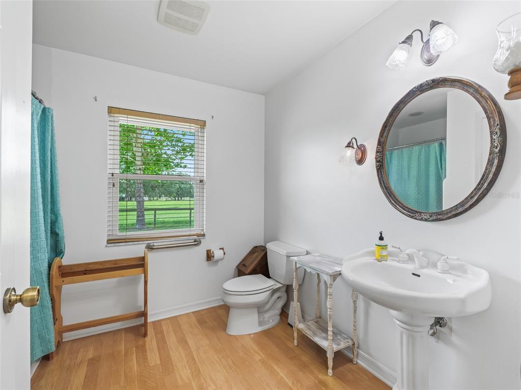 1500 Northwest 155th Street Citra, FL 32113 - Photo 23 of 43 a bathroom with a toilet a sink and a mirror