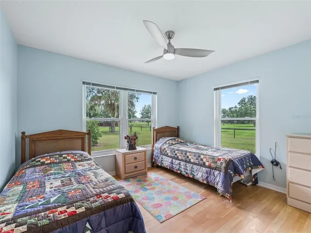 a bedroom with two beds and a large window