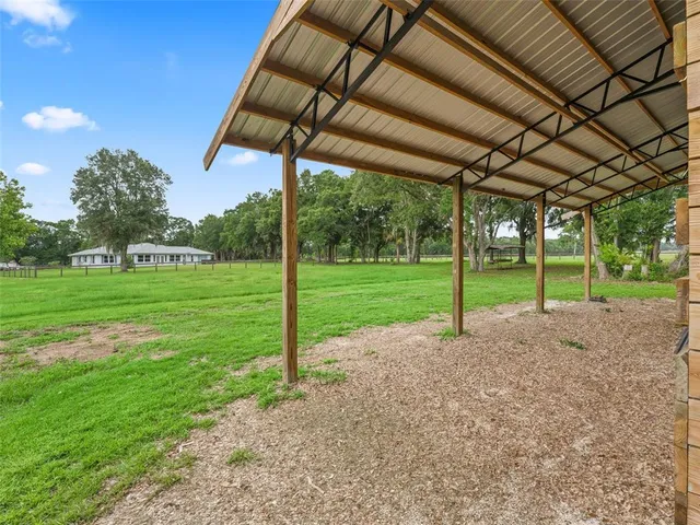 a view of a yard with porch and sitting area