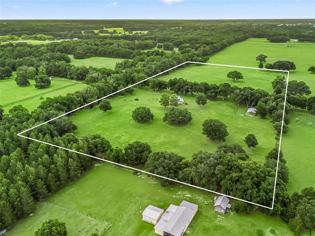 1500 Northwest 155th Street Citra, FL 32113 - Photo 42 of 43 a view of a green field with sitting area