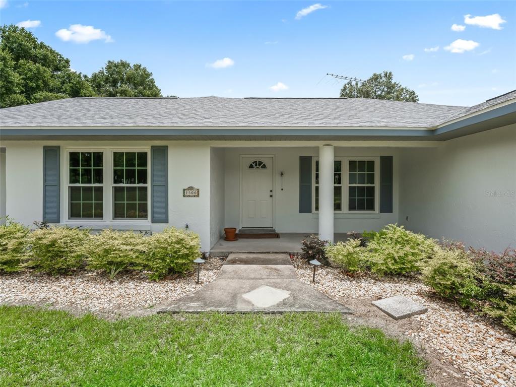 1500 Northwest 155th Street Citra, FL 32113 - Photo 5 of 43 a front view of a house with garden