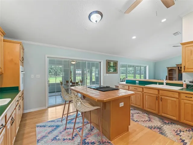 a room with stainless steel appliances granite countertop a sink and a stove