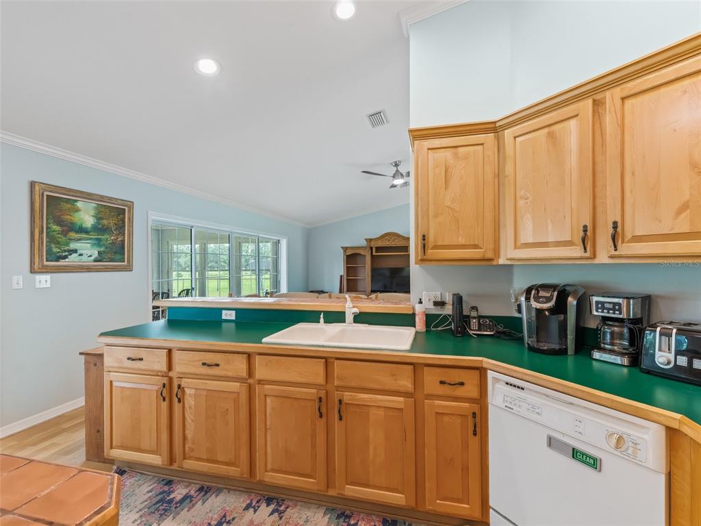 1500 Northwest 155th Street Citra, FL 32113 - Photo 10 of 43 a kitchen with kitchen island granite countertop a sink and a stove top oven