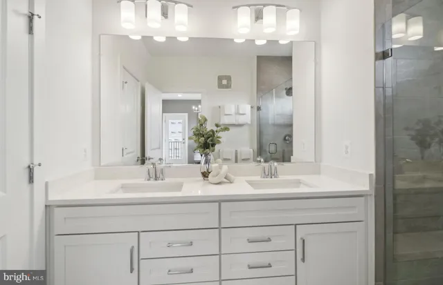 a spacious bedroom with a bed and a chandelier