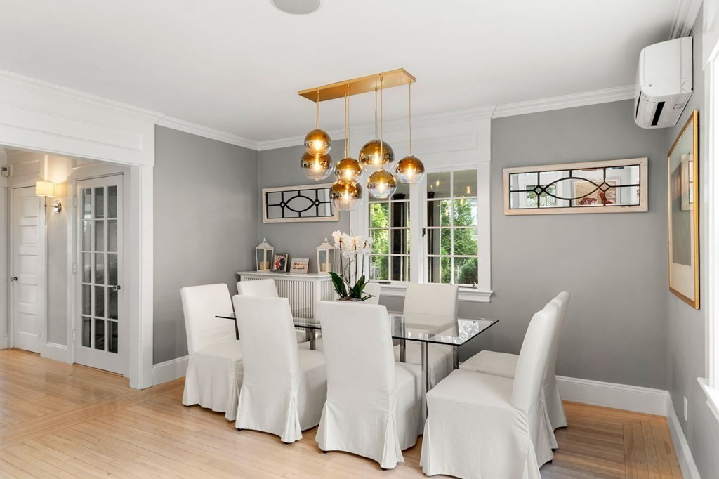 63 Nehoiden Road Newton, MA 02468 - Photo 8 of 22 a view of a dining room with furniture a chandelier and wooden floor