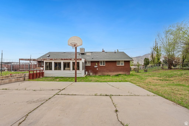 149 West 1600th Street South Mapleton, UT 84664 - Photo 41 of 44 Back of house with brick siding, a patio, a fenced backyard, and roof with shingles