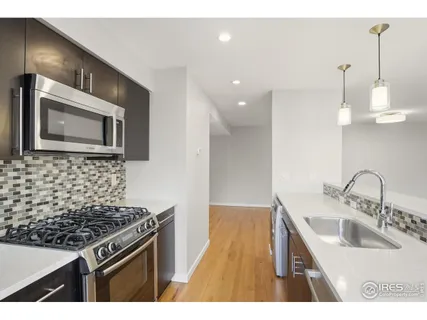 a kitchen with a sink stove and microwave