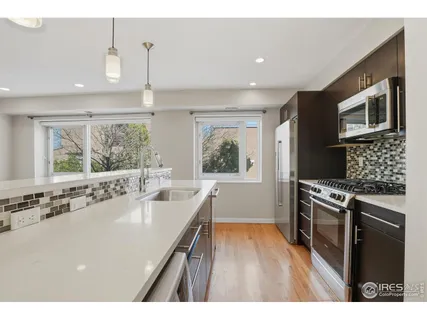 a kitchen with a stove a sink and a microwave