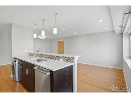 a kitchen with a sink cabinets and wooden floor